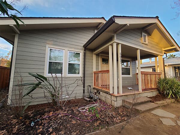 Light gray home with horizontal siding and covered porch