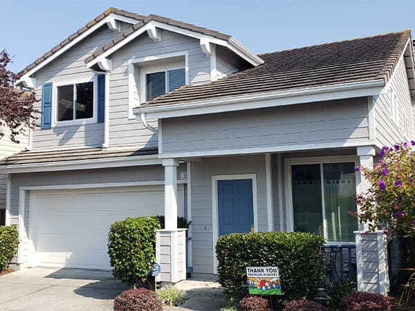 Blue-gray home with horizontal siding, white trim, and attached garage